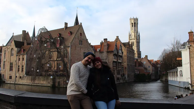 Inma y Álex en el puente del Rozenhoedkaai de Brujas, con los canales y el Belfort al fondo
