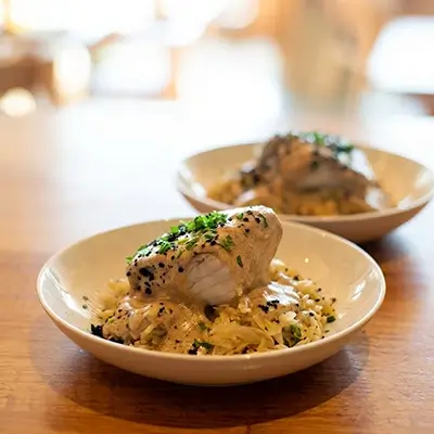 Bacalao en salsa cremosa sobre patata paja, plato típico portugués