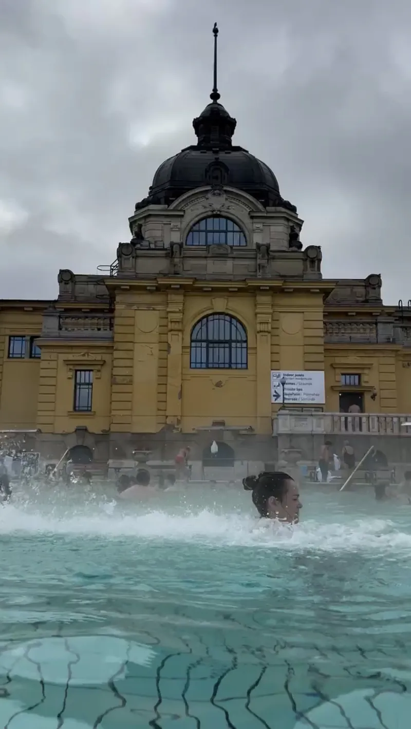 Inma en la piscina exterior de los baños Széchenyi de Budapest, con el edificio amarillo y su cúpula al fondo